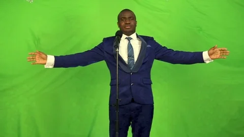 Young black man singing into microphone in a suit and tie. Stock Footage 74878102