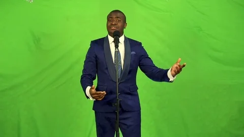 Young black man singing into microphone and quietly dancing. Stock Footage 74880587