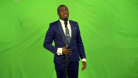 Young black man singing into microphone and quietly dancing. 스톡 동영상 74882681
