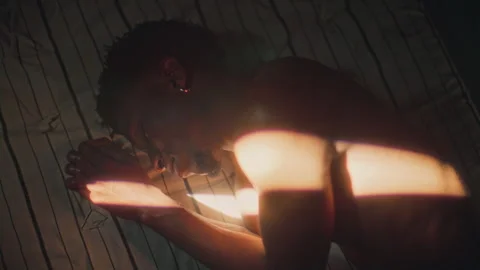 Young Black Man Sleeping on Bed Illuminated by Morning Sunlight Stock Footage 316543071