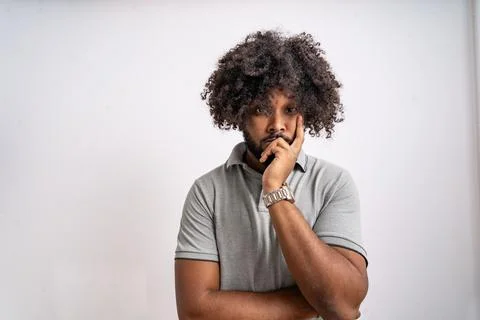 Young black man thinking deeply, hand on chin Stock Photos