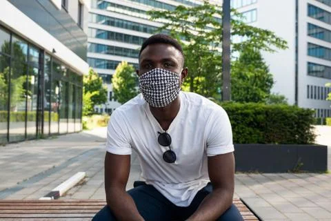 Young Black Man Wearing Face Mask Looking at Camera