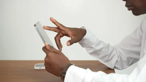 Young black man working on a tablet in an office at a table 스톡 동영상 278477618