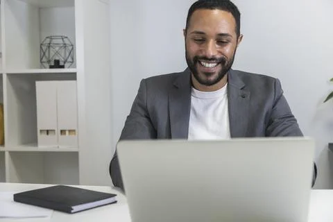 Young black man working using his laptop on online business meeting. Copy space. Stock Photos