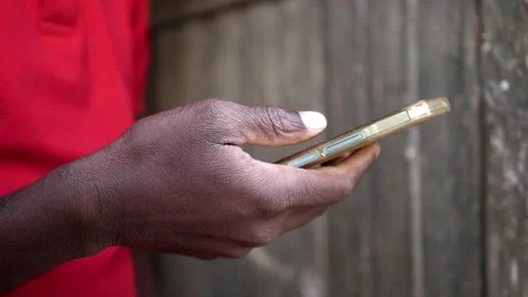 Young black man's hand using smartphone in the street Video stock 213263914