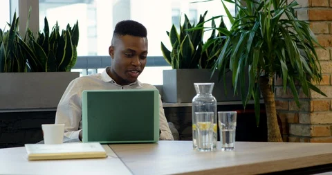 Young Black Office Worker Getting Advice from Disabled Colleague - Medium Dolly Stock-Footage 129024566