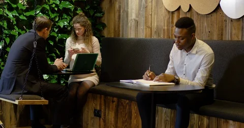 Young Black Office Worker Getting Advice from Disabled Colleagues - Medium Dolly Stock Footage 129032969
