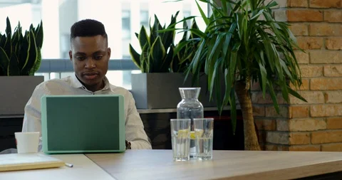 Young Black Office Worker Getting Advice from Disabled Colleague - Medium Dolly Stock Footage 129034417