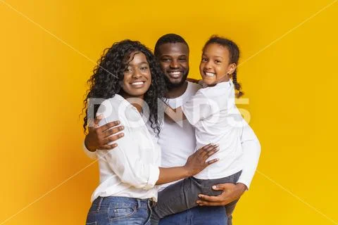 Young Black Parents With Cute Little Daughter Over Yellow Background
