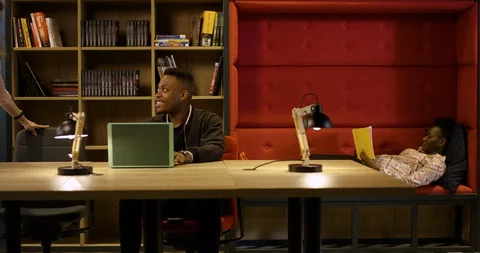 Young Black Professional Giving Advice to Diverse Coworkers in Modern Office Stock Footage 129042053