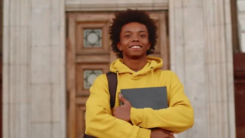 Young black programmer in a casual clothes with a laptop and backpack looking Stock Footage 274552382