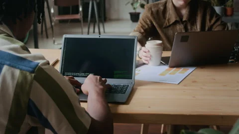 Young Black Programmer Coding on Laptop at Desk in Office Stock Footage 306213165