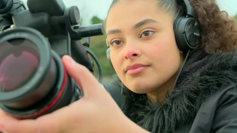 Young black woman camera operator filming close up Stock Footage 259809604