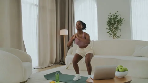 Young black woman doing a workout at home Stock Footage 274441953