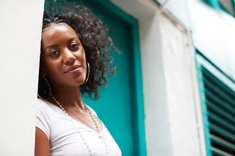 Young black woman in doorway smiling to camera, close up Stock Photos