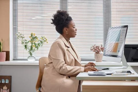 Young Black Woman Using Computer at Workplace Stock Photos