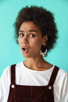 Young black woman wearing earrings expressing surprise at camera Stock Photos