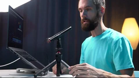 A young blogger sets up and tests a microphone in his studio Stock Footage 279377904