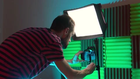 A young blogger sets up a smartphone and other equipment to videotape a podcast Stock Footage 237092221