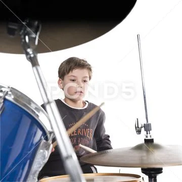 Young blond boy at drum kit in studio Stock Photos
