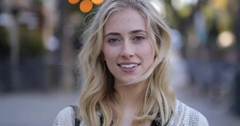 Young blond caucasian woman face portrait outdoor street city smiling happy Stock Footage