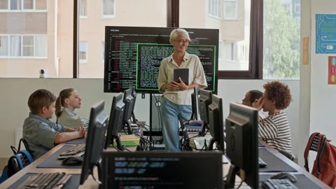 Young Blond Female Teacher of Programming Talking to Schoolkids at Lesson Stock Footage 316479286