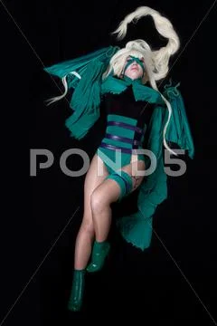 Young blond girl in green banshee cosplay costume Stock Photos