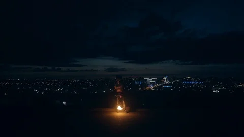 Young blond male does fire show in the middle of the night spins burning torch Stock Footage 105219449