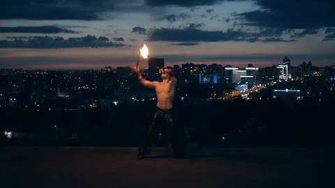 Young blond male does tricks with fire, Male breaths fireballs multiple times. Stock-Footage 105212889