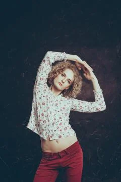 A young blond man androgyn in the image of an attractive woman in a blouse wi Stock Photos