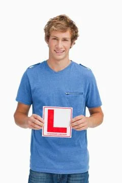 Young blond man holding a learner driver sign Stock Photos