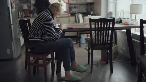 Young Blond Man Sits Kitchen Home And Uses Smartphone For Communication Stock Footage 143798458