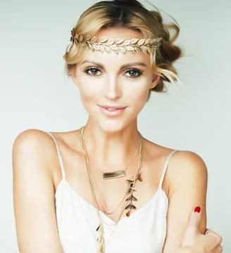 Young blond woman dressed like ancient greek godess, gold jewelry close up Stock Photos