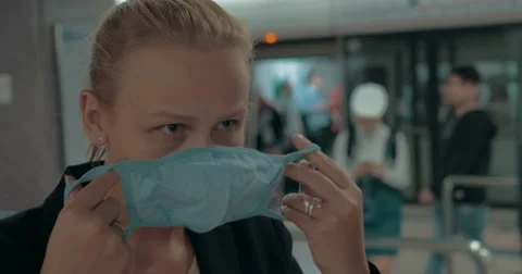 Young blond woman wearing surgical mask in metro. Wuhan, China Stock Footage