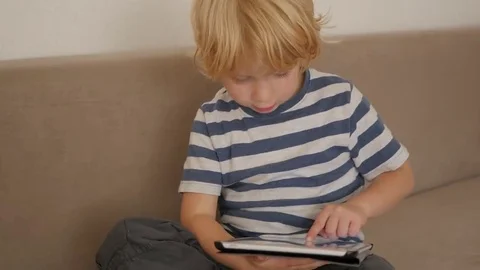 A young blonde boy with a tablet computer 스톡 동영상 69208439