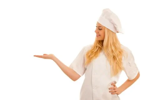 Young blonde chef points to copy space as she presents a new recepy isolated  Foto stock