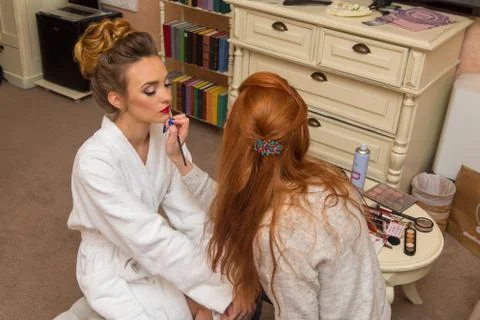 Young blonde doing makeup on the face Stock Photos