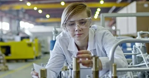 Young Blonde Female Engineer Inspecting Factory Machine Stock Footage