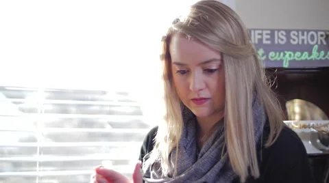Young Blonde Female Inside Looking Down Using Smart Device Video stock 62822555