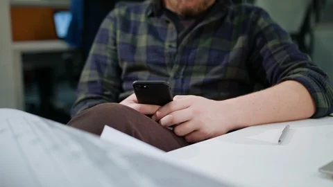 A Young Blonde Man Using a Phone in the Office Stock Footage 86356980