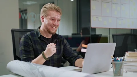 A Young Blonde Man Working on the Laptop Indoors Stock Footage 86366199