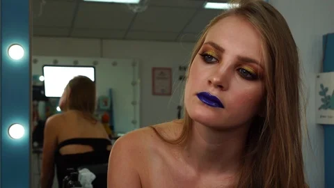 Young blonde model in total professional female makeup look in bright colored Video stock 102735078