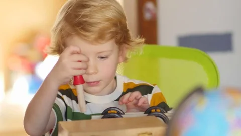 Young blonde pre-school boy screwing with screwdriver at constructor toy 스톡 동영상 71767948