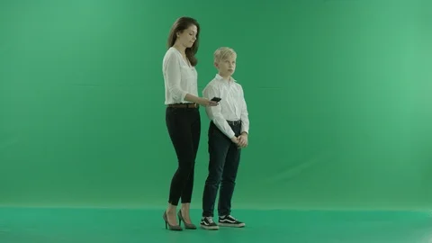A young blonde school boy in school uniform and a young lady are having a video Stock Footage 115844832