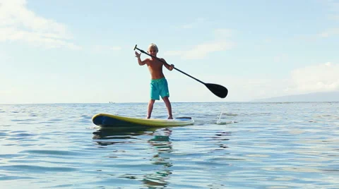 Young Blonde Surfer Boy Stand Up Paddling. Видео 54301252