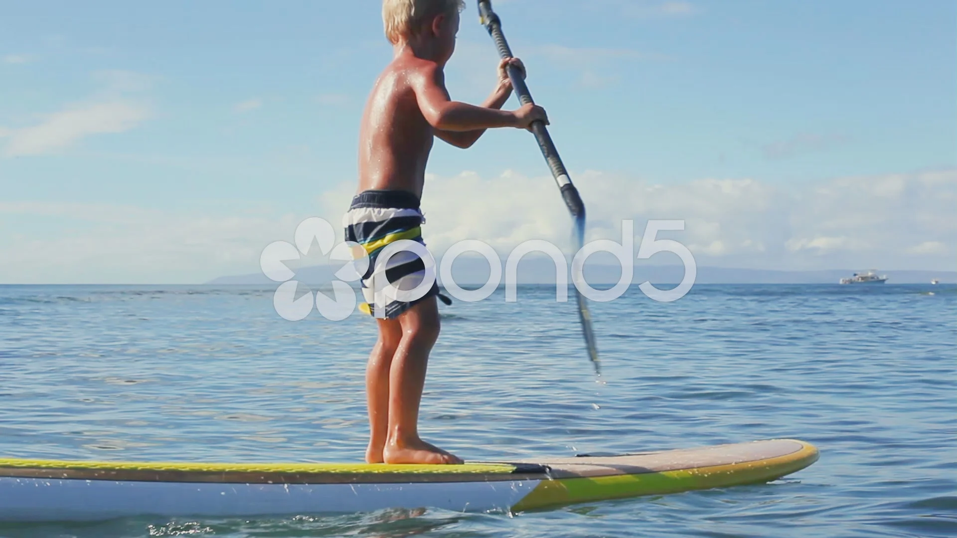 Young Blonde Surfer Boy Stand Up Paddling.