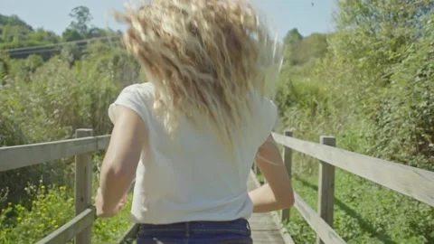 Young blonde woman running Stock Footage