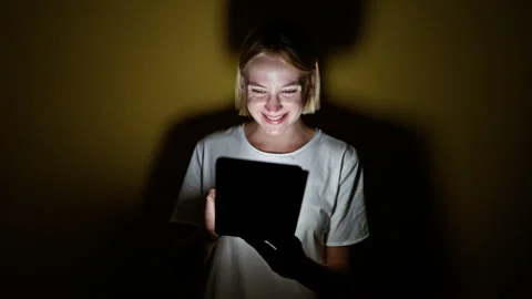 Young blonde woman using touchpad smiling over isolated yellow background Stock Footage 247379853