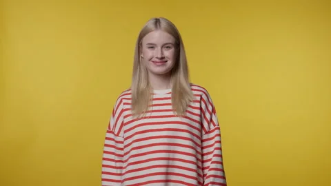 Young Blonde Woman Winking At Camera On Yellow Background Stock Footage 336784178