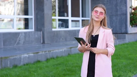 Young blonde working on tablet pc in city. Female using wireless internet on the Video stock 94190973